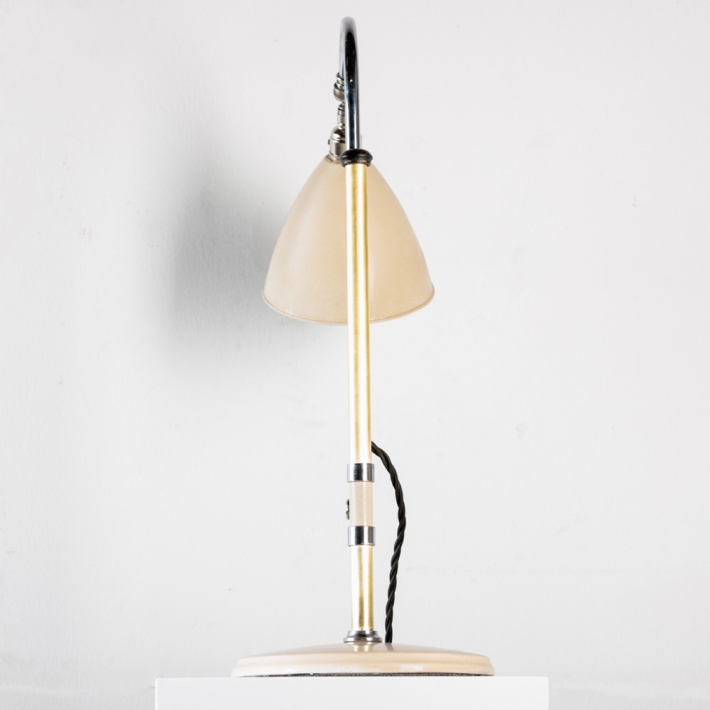 A 1930s Bestlite desk lamp featuring a cream enamelled shade and base, a curved chrome gooseneck arm, and an adjustable brass stem. View VIII