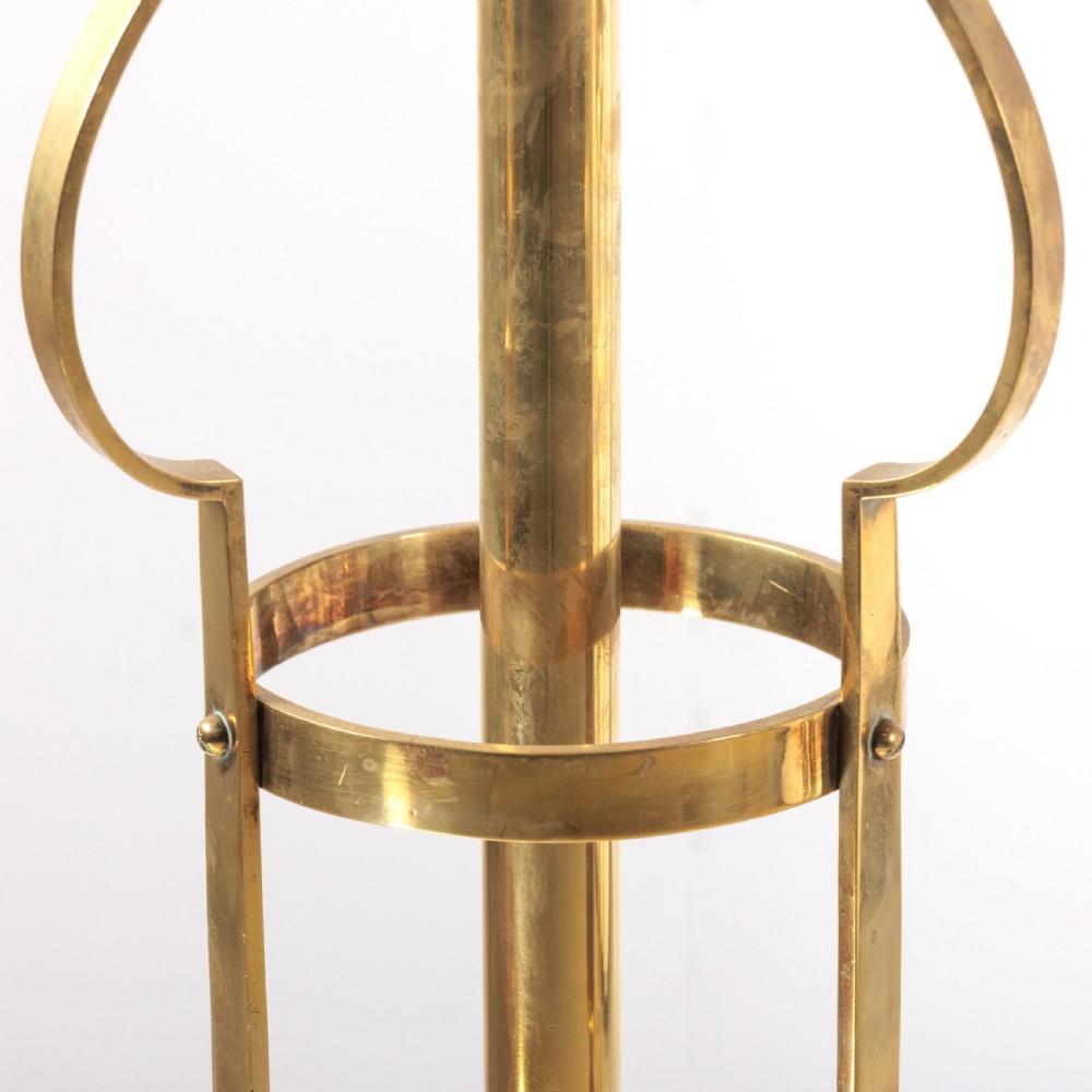 A pair of antique brass standard floor lamps featuring tripod bases, scrolled design details, and green striped pleated fabric shades. View IV