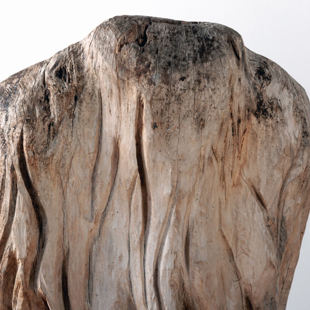 A pair of hand-carved dugout garden seats crafted from solid tree trunks with weathered timber surfaces. View VII