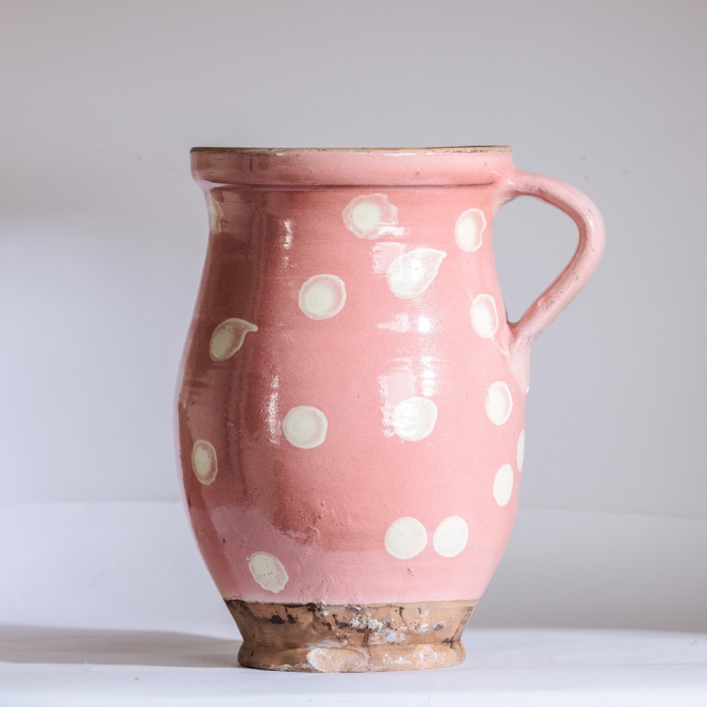 A collection of twelve 19th-century earthenware jugs in varying sizes and colours, each decorated with hand-painted spot and polka dot motifs. View II