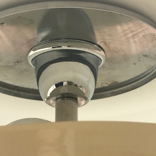 fig 1. An Art Deco style table lamp featuring a chrome cylindrical stem on a stepped circular base, topped with a cream bowl accent and a broad dark brown metal dome shade.