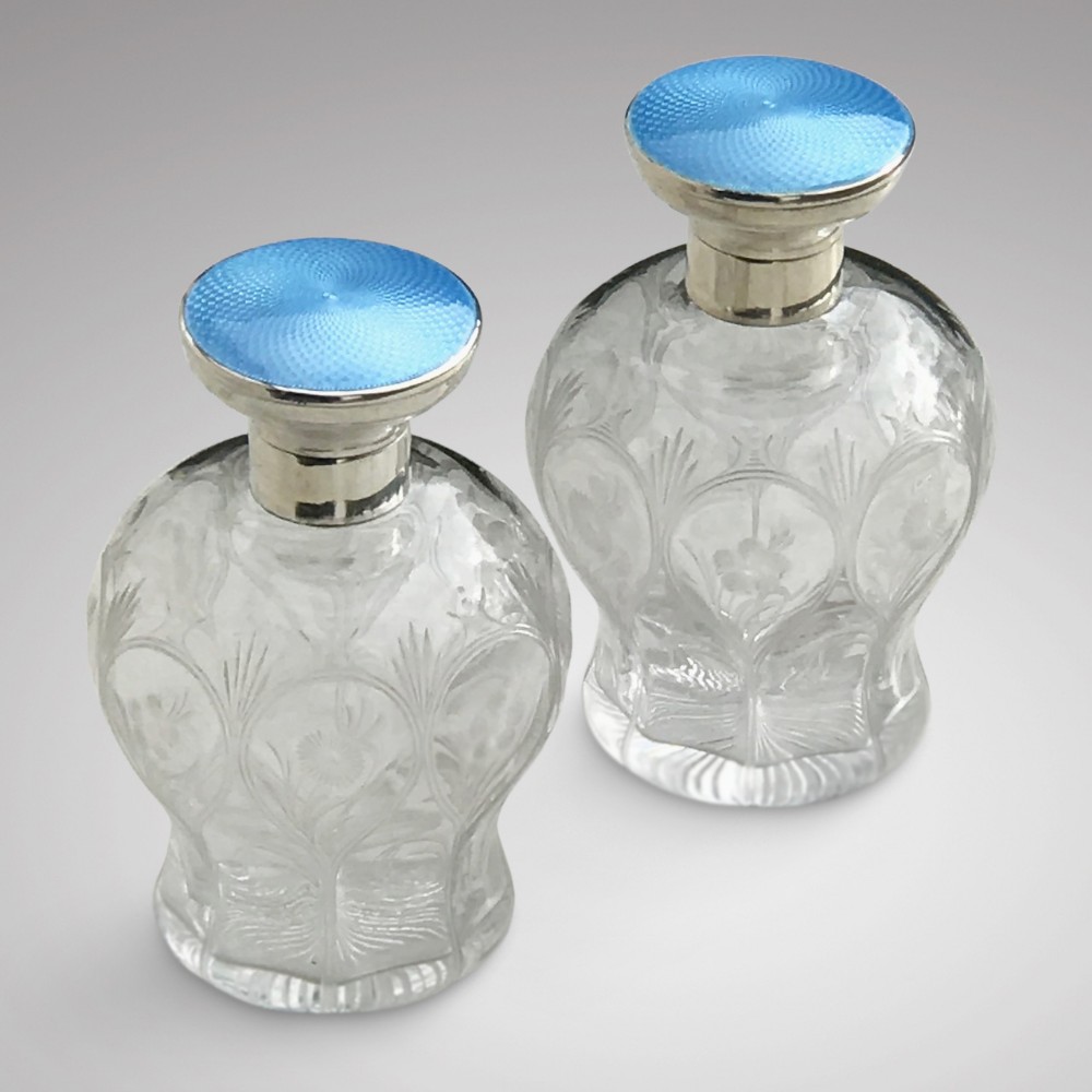 PAIR OF LARGE EARLY 20TH CENTURY SILVER AND ENAMEL TOPPED SCENT BOTTLES