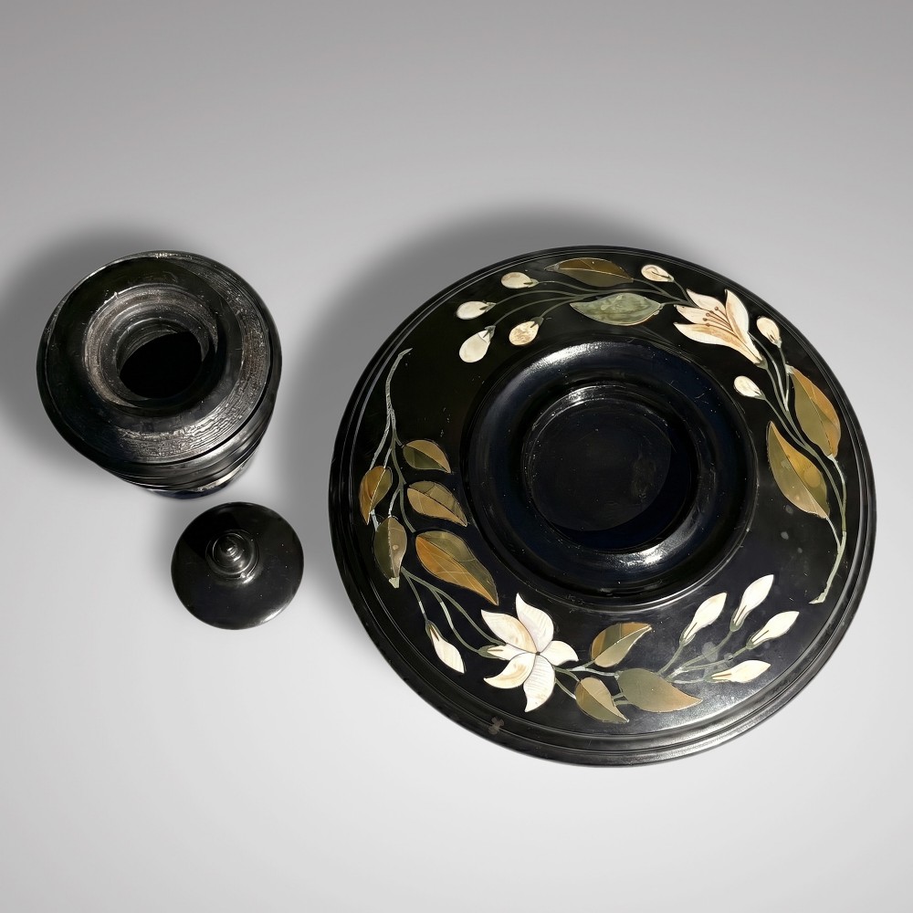 A circular black marble inkwell stand featuring detailed floral hardstone inlays and a central covered ink pot. View II