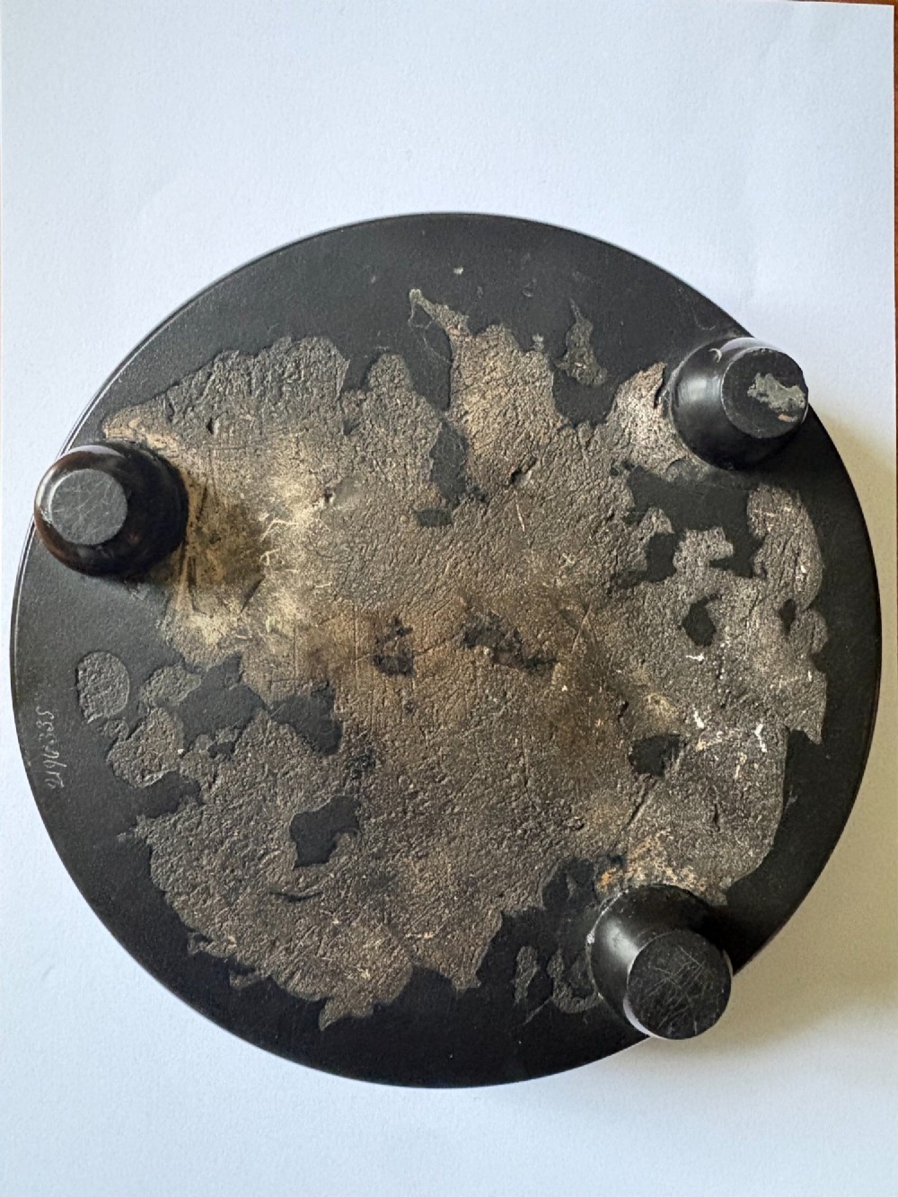 A circular black marble inkwell stand featuring detailed floral hardstone inlays and a central covered ink pot. View III