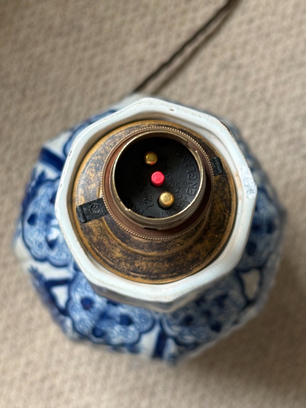 A pair of 19th-century blue and white Delftware ceramic table lamps with hand-painted figurative scenes, mounted on dark timber bases with cream scalloped shades. View V