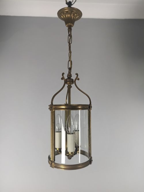 fig 2. A cylindrical French gilt brass hall lantern with etched curved glass panels housing a three-bulb candle fitting.