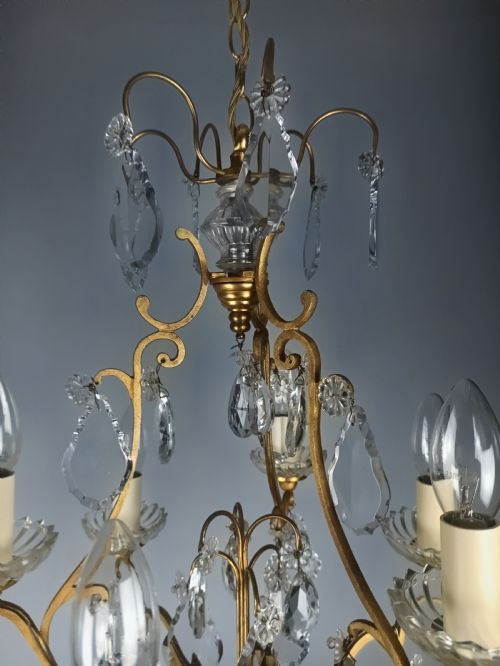 fig 1. A French six-light birdcage chandelier featuring a gilded scroll frame decorated with clear faceted crystal drops and glass candle drip pans.