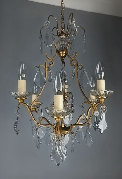 fig 2. A French six-light birdcage chandelier featuring a gilded scroll frame decorated with clear faceted crystal drops and glass candle drip pans.