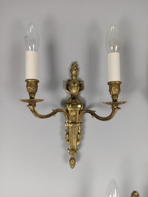 fig 2. Set of three French Louis XVI style twin-arm wall lights in gilded metal with urn backplates and fluted shafts.