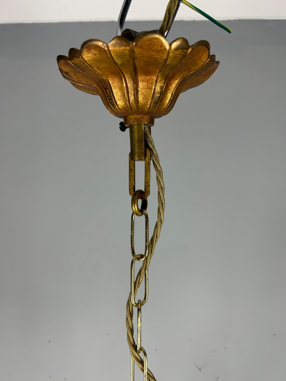 A French brass six-light chandelier featuring curved scroll arms, candle sleeves, and suspended faceted crystal glass droplets. View XI
