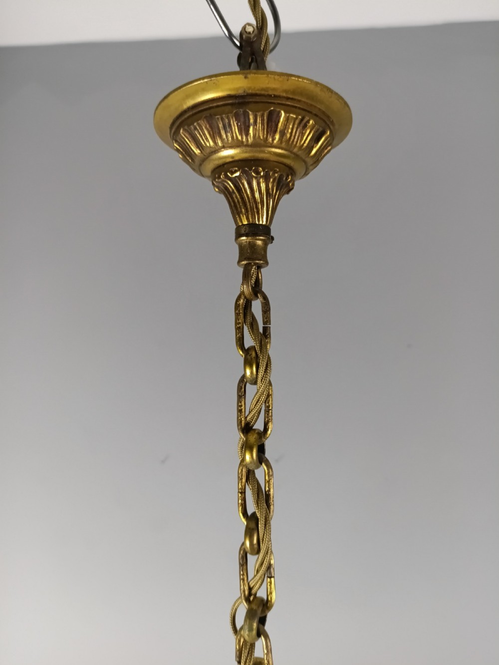 A French gilt brass three-arm chandelier featuring curved scrollwork arms, candle-style lamp holders, and dangling faceted crystal droplets. View II