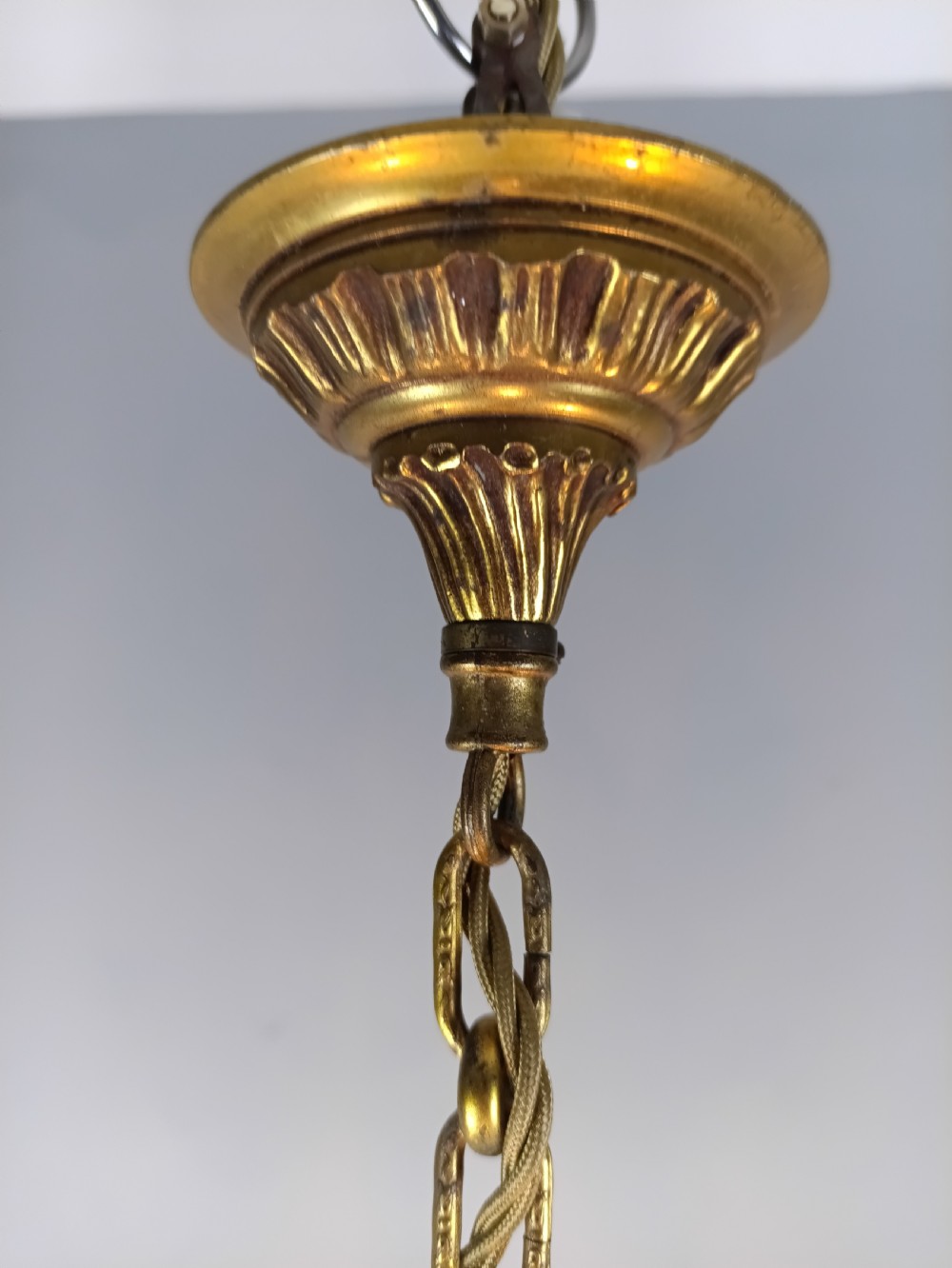 A French gilt brass three-arm chandelier featuring curved scrollwork arms, candle-style lamp holders, and dangling faceted crystal droplets. View VII