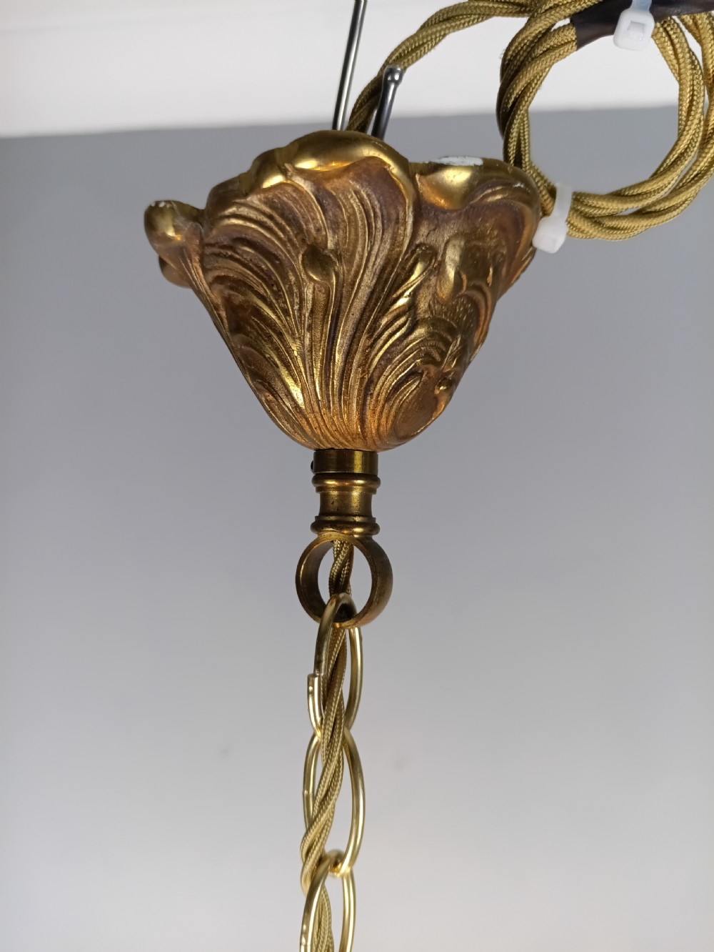 A French gilded brass four-light chandelier adorned with faceted crystal drops and a central crystal sphere finial. View XIV