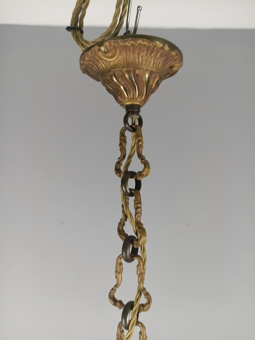 A French gilt brass five-arm chandelier featuring scrolling branch arms, candle bulb sleeves, and an ornate central column. View XI