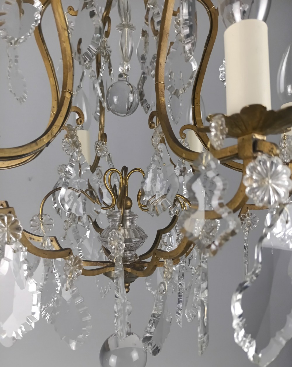 An antique French six-light birdcage chandelier featuring a gilded frame hung with clear crystal drops and glass rosettes. View III
