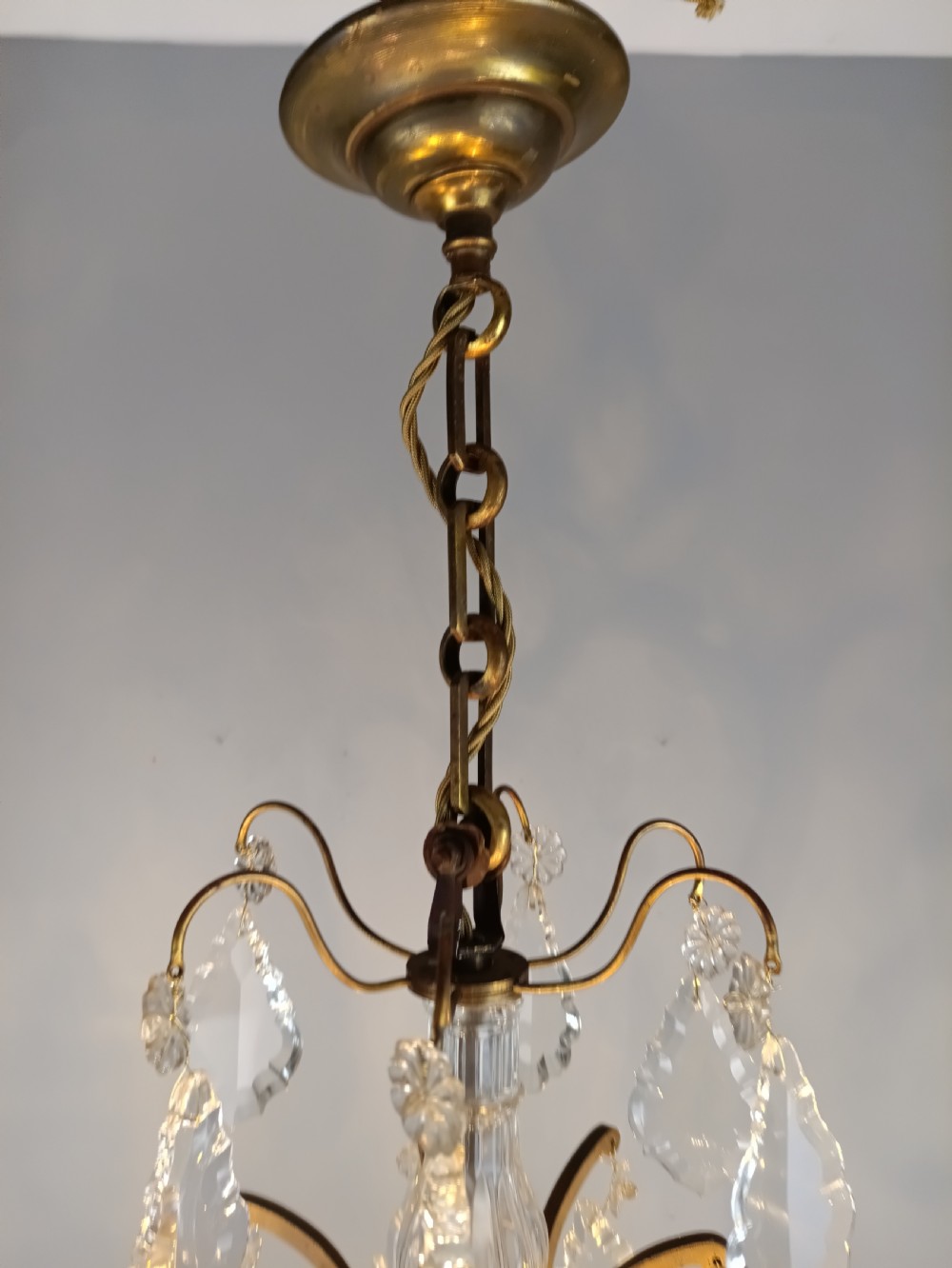 An antique French six-light birdcage chandelier featuring a gilded frame hung with clear crystal drops and glass rosettes. View VIII