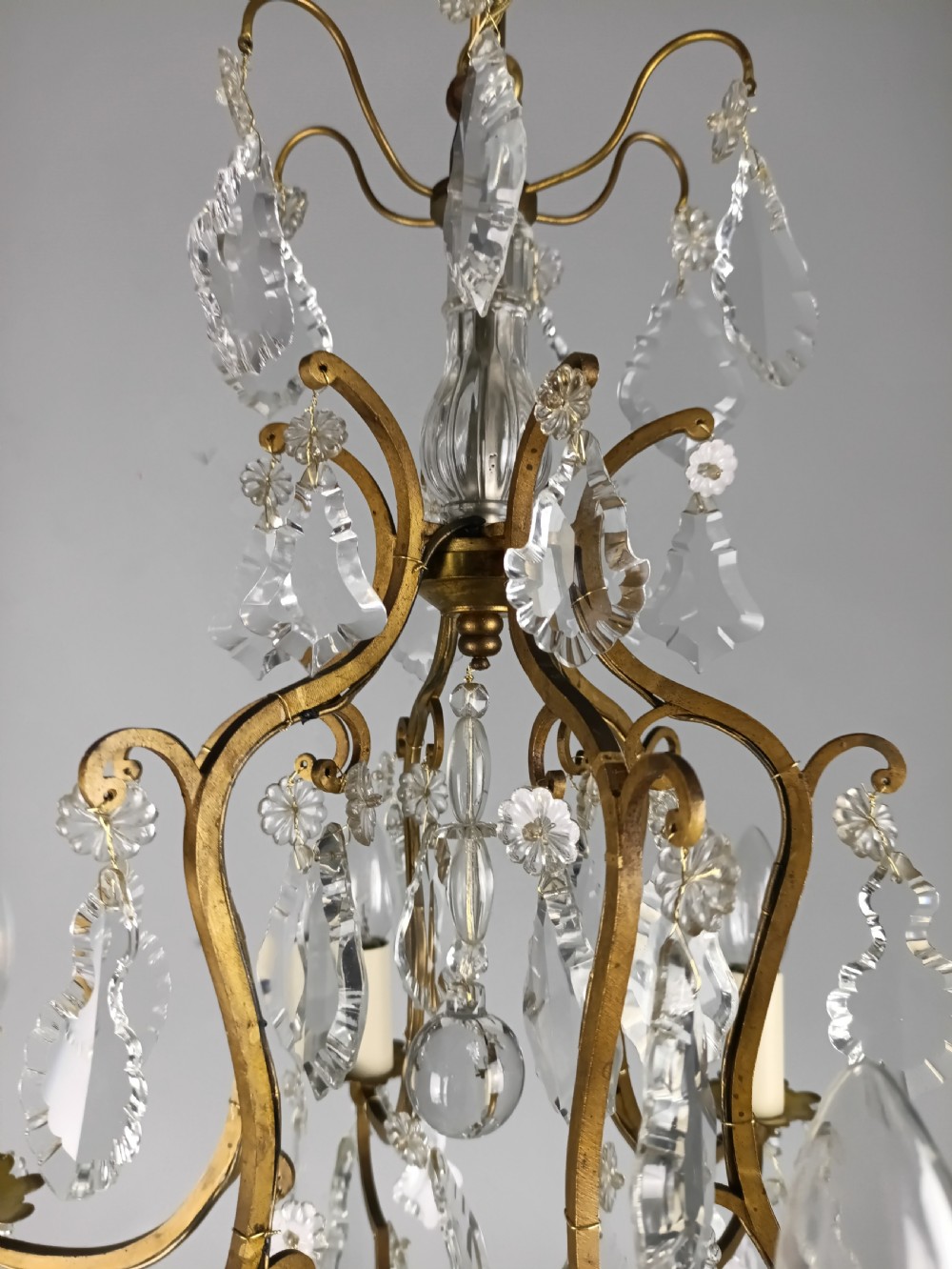 An antique French six-light birdcage chandelier featuring a gilded frame hung with clear crystal drops and glass rosettes. View IX