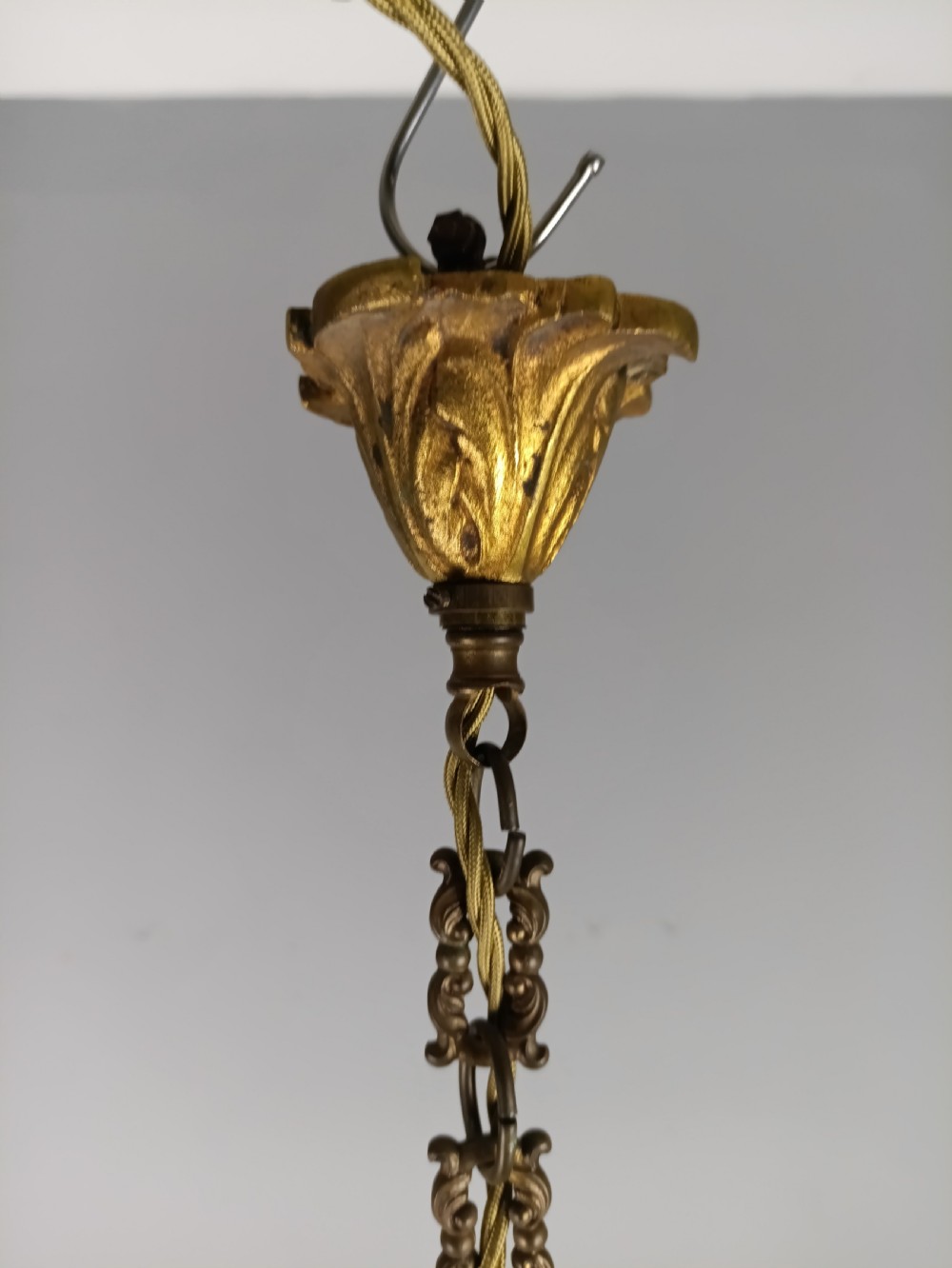 A French five-light gilded brass frame chandelier featuring scrolled arms, candle sleeves, and suspended cut crystal drops. View IX