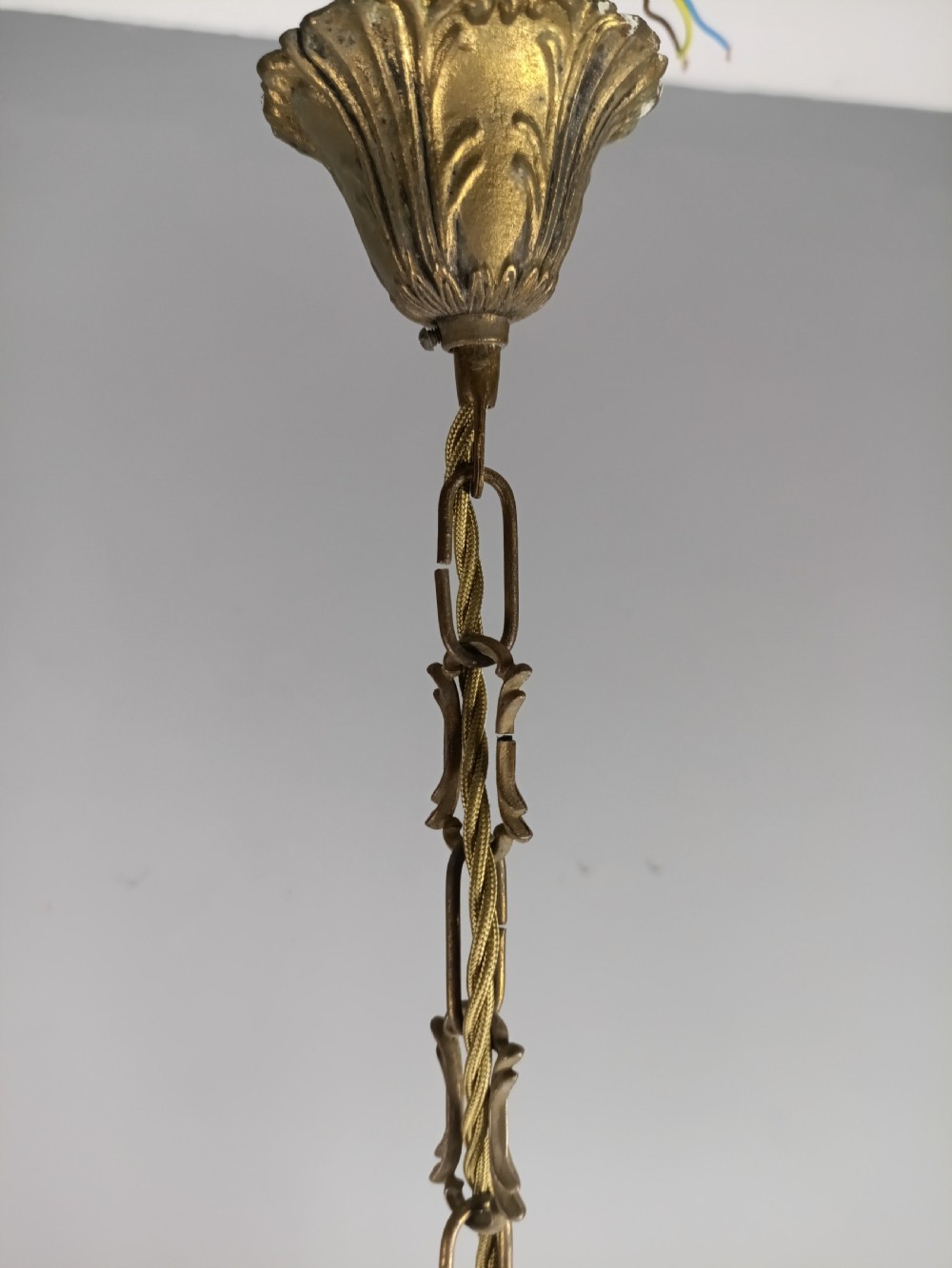A French style gilt brass ten-light chandelier featuring curved candle arms, glass bobeches, and faceted hanging glass drops. View IV