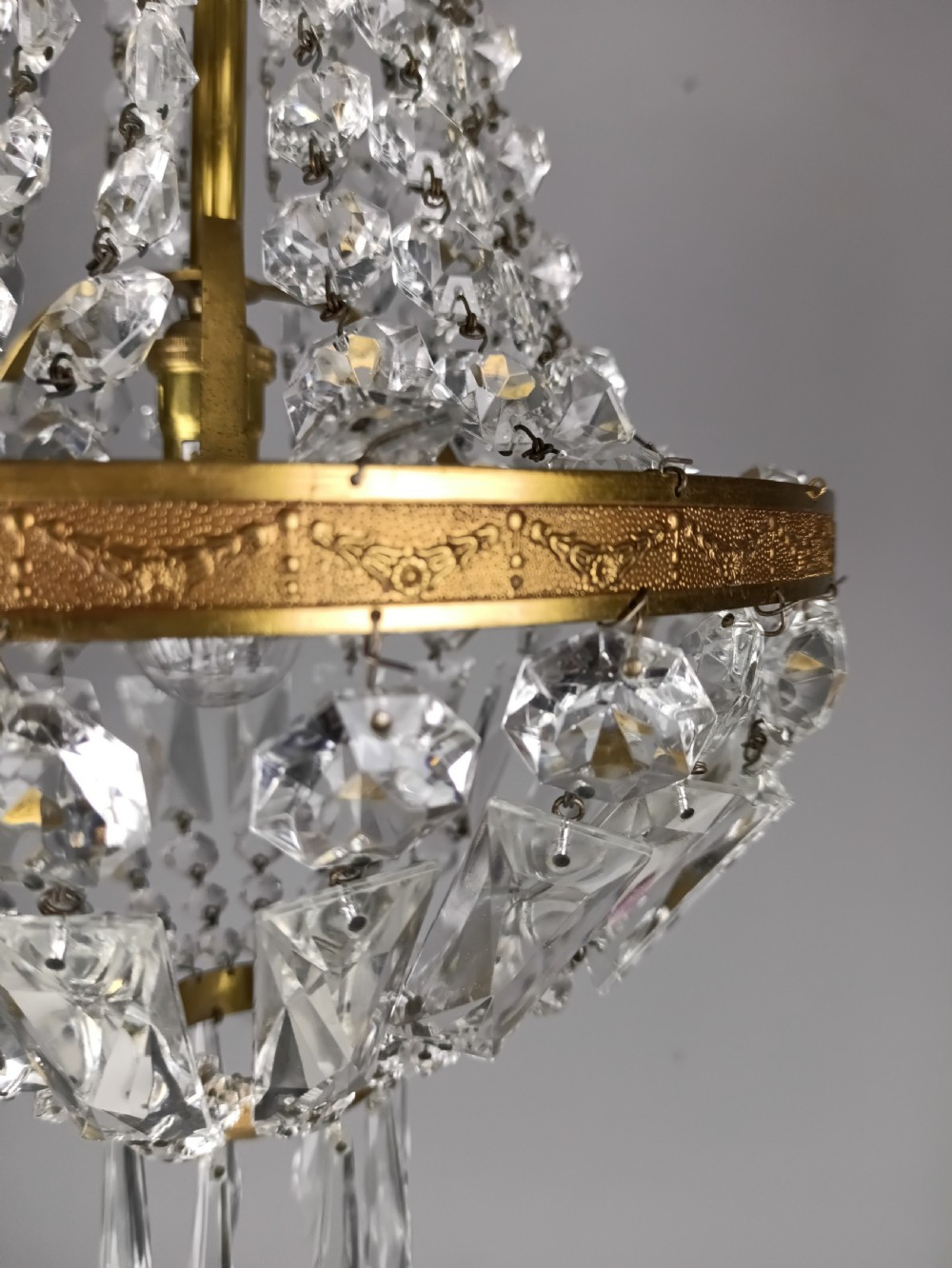 An antique French tent and bag chandelier featuring cascading crystal beads attached to a decorative brass rim with cut glass prisms below. View III