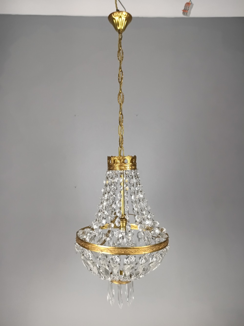 An antique French tent and bag chandelier featuring cascading crystal beads attached to a decorative brass rim with cut glass prisms below. View VIII