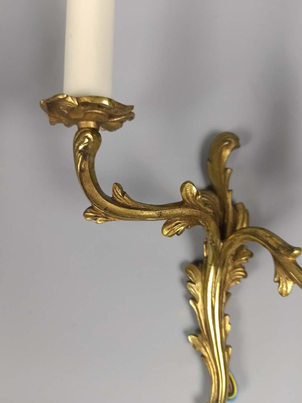 A pair of French gilt brass two-arm wall sconces featuring acanthus leaf scrollwork and candle-style bulb holders. View III