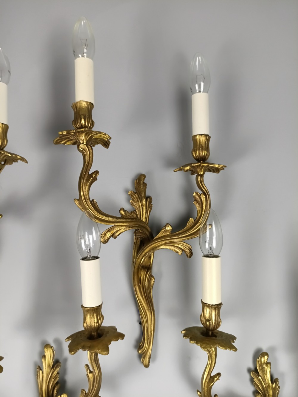 Set of four French Rococo style gilt brass twin-arm wall sconces featuring acanthus leaf motifs. View VI