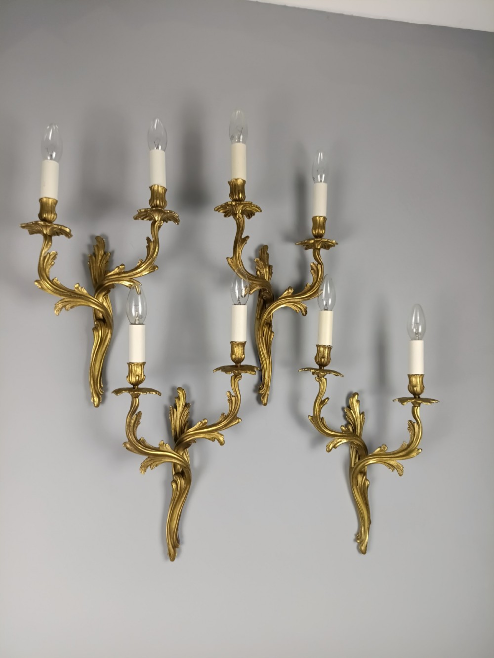 Set of four French Rococo style gilt brass twin-arm wall sconces featuring acanthus leaf motifs. View VII