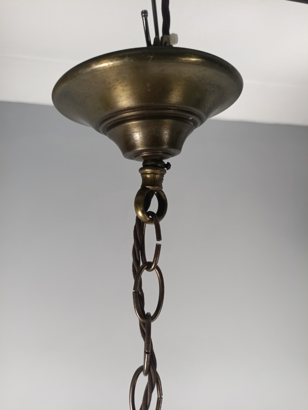 A cylindrical gilded brass hall lantern featuring curved clear glass panels and an internal three-light candle cluster. View IX
