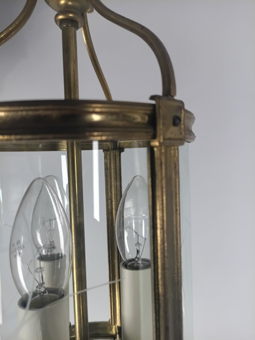 A cylindrical French gilt brass hall lantern with etched curved glass panels housing a three-bulb candle fitting. View VI