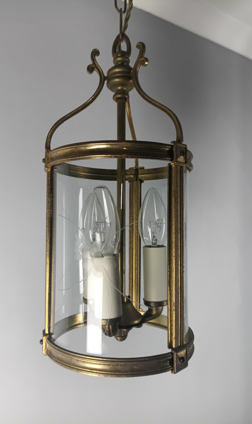 A cylindrical French gilt brass hall lantern with etched curved glass panels housing a three-bulb candle fitting. View X