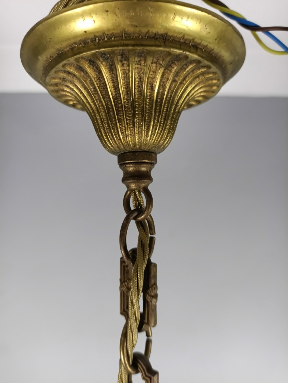 A three-arm gilt brass ceiling chandelier featuring scrolled branches, acanthus leaf decoration, and a central tapered column suspended by a chain. View VIII