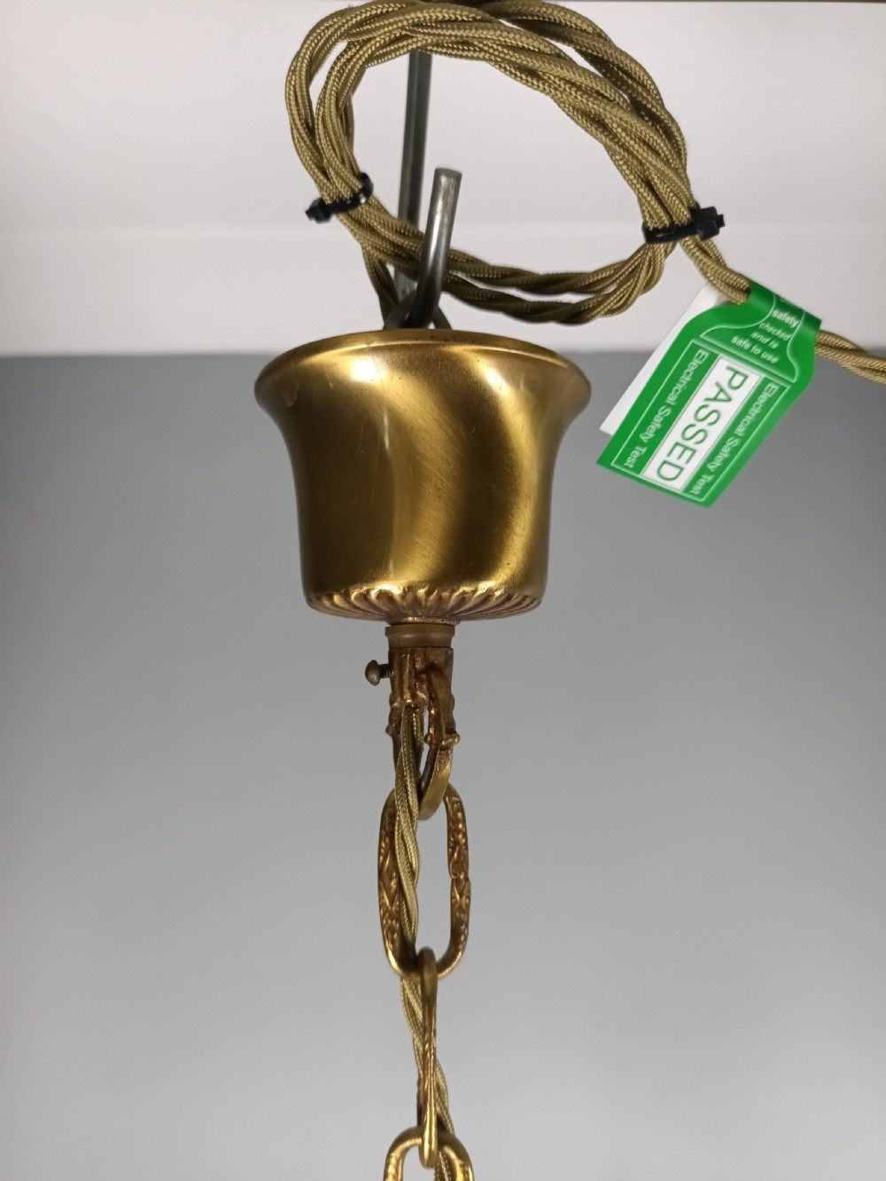 A French five-light gilt bronze chandelier featuring scrolling Rococo arms, candle-style bulb holders, and a central chased stem. View VI