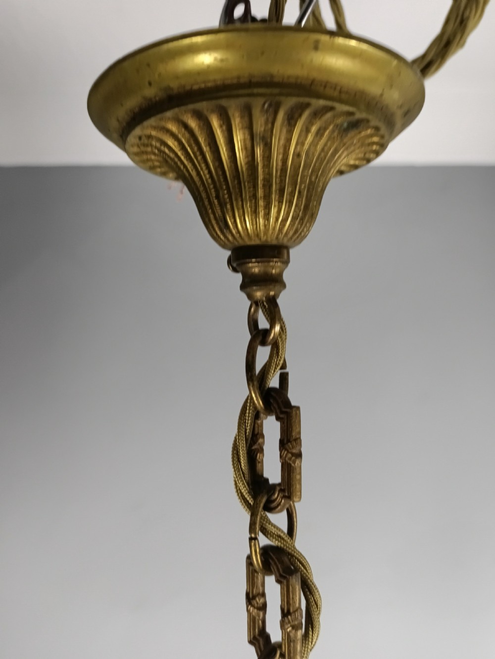 A pair of French gilt brass three-arm chandeliers featuring scrolling branches and fluted central columns suspended from metal chains. View V