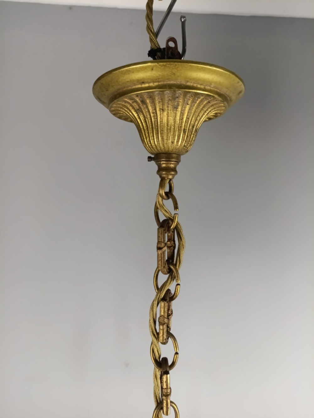 A pair of three-arm French gilt brass chandeliers featuring scrolling arms, central baluster shafts, and candle-style sockets. View VII