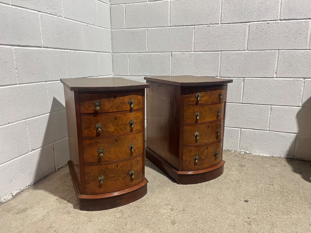 A pair of 19th-century mahogany bedside chests with curved bowfront drawers and ornamental brass drop handles. View III