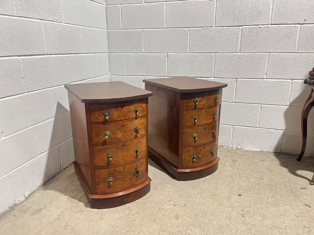 A pair of 19th-century mahogany bedside chests with curved bowfront drawers and ornamental brass drop handles. View VI