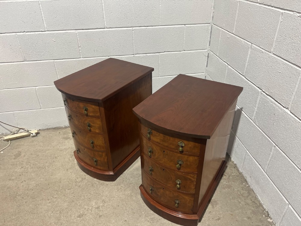 A pair of 19th-century mahogany bedside chests with curved bowfront drawers and ornamental brass drop handles. View VII
