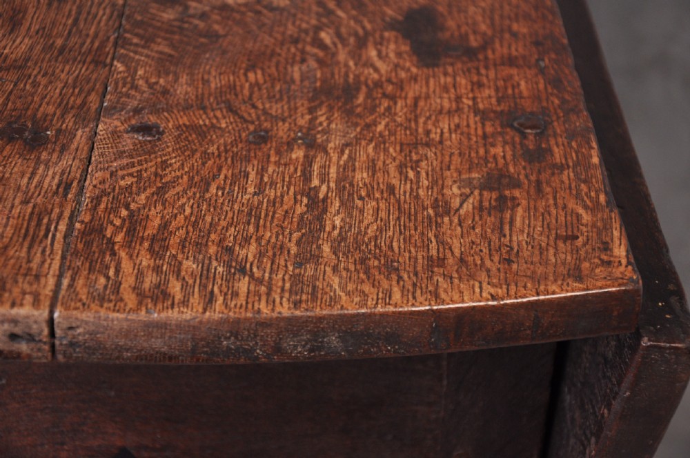 A late seventeenth-century oak gateleg dining table featuring an oval top, turned legs, drop leaves, and a stretcher base. View V