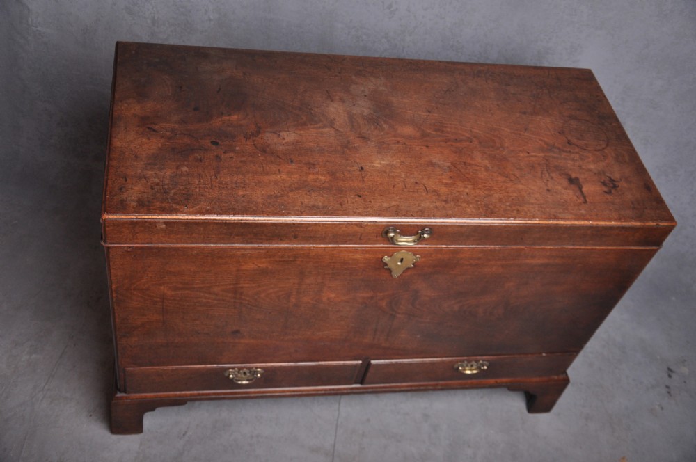 An 18th-century mahogany silver chest featuring a hinged lid, twin base drawers, side carrying handles, and bracket feet. View II