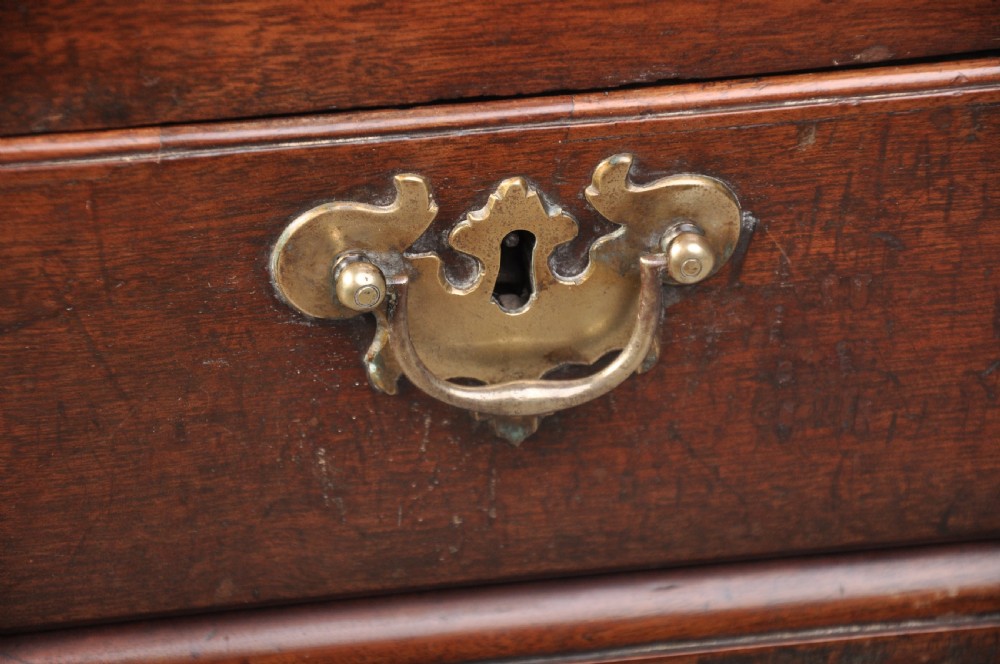 An 18th-century mahogany silver chest featuring a hinged lid, twin base drawers, side carrying handles, and bracket feet. View V