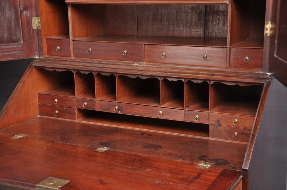 An 18th-century mahogany bureau bookcase featuring a blind two-door upper cabinet, a slant-front writing slope, four long drawers, and bracket feet. View III
