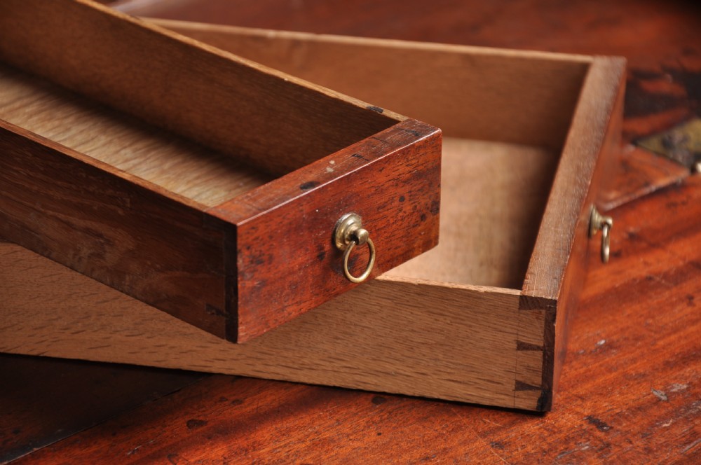 An 18th-century mahogany bureau bookcase featuring a blind two-door upper cabinet, a slant-front writing slope, four long drawers, and bracket feet. View IV