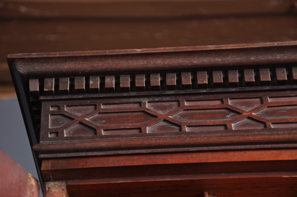 An 18th-century mahogany bureau bookcase featuring a blind two-door upper cabinet, a slant-front writing slope, four long drawers, and bracket feet. View V