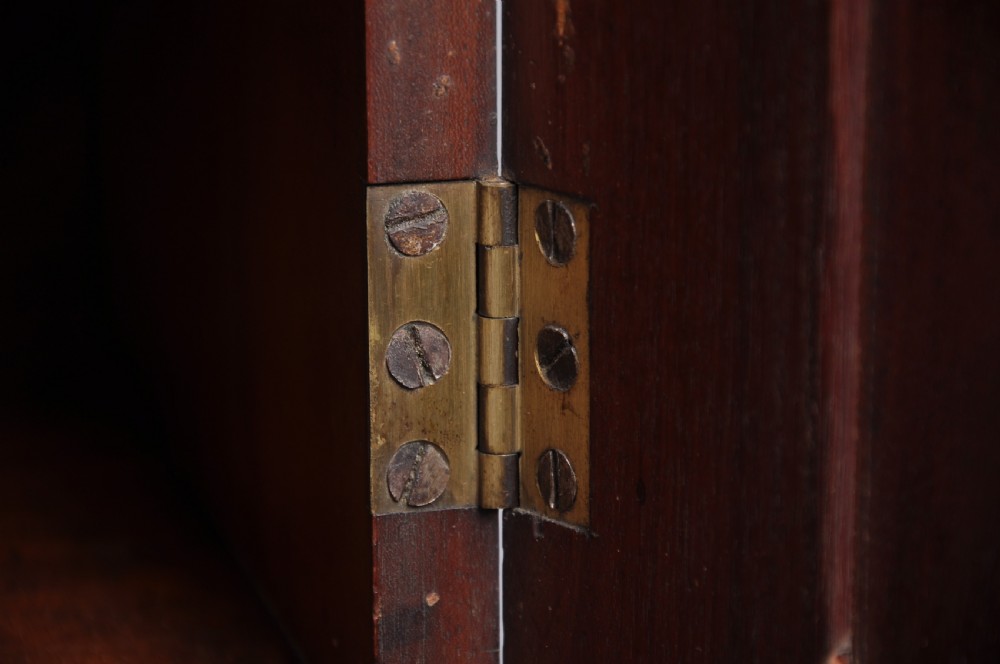 An 18th-century mahogany bureau bookcase featuring a blind two-door upper cabinet, a slant-front writing slope, four long drawers, and bracket feet. View VI