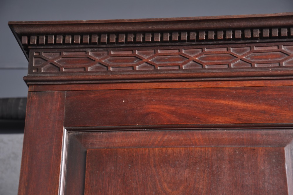 An 18th-century mahogany bureau bookcase featuring a blind two-door upper cabinet, a slant-front writing slope, four long drawers, and bracket feet. View VIII