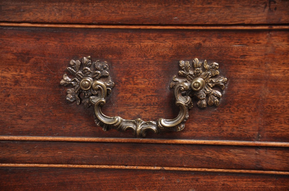 An 18th-century mahogany bureau bookcase featuring a blind two-door upper cabinet, a slant-front writing slope, four long drawers, and bracket feet. View IX