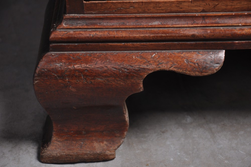 An 18th-century mahogany bureau bookcase featuring a blind two-door upper cabinet, a slant-front writing slope, four long drawers, and bracket feet. View XI