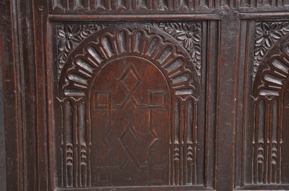 A dark oak three-panel coffer featuring relief-carved arches, geometric strapwork, a carved frieze, and a central iron keyhole plate. View II