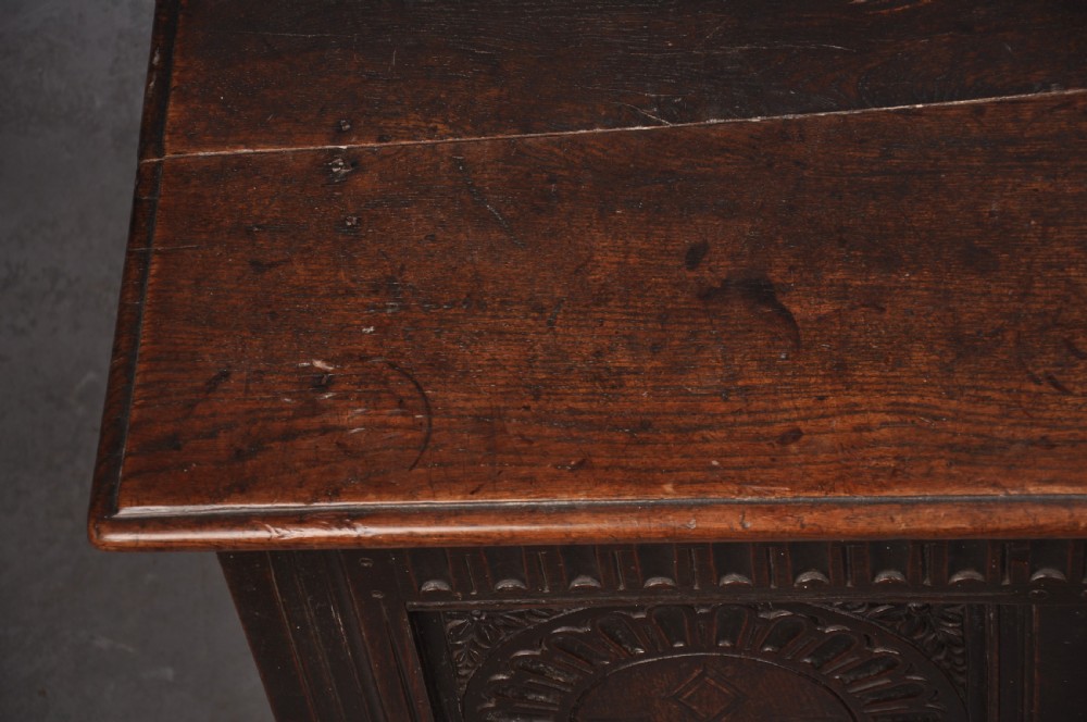 A dark oak three-panel coffer featuring relief-carved arches, geometric strapwork, a carved frieze, and a central iron keyhole plate. View VII